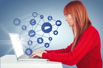 Composite image of smiling hipster woman using laptop