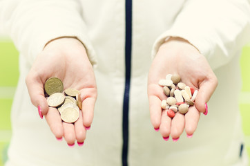 Woman´s hands holdin pills and money. Pharmaceutical background. Corruption. Balance of money and pills. 