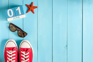 June 1st. Image of june 1 wooden color calendar on blue background.  First summer day. Empty space...