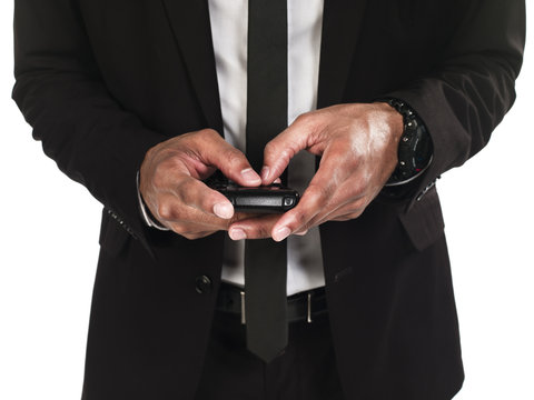 front view mid section of business man text messaging.