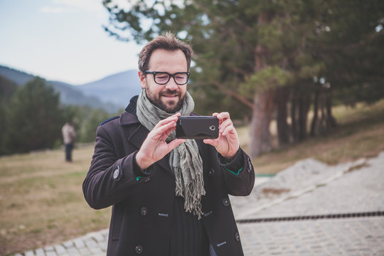 Man taking a photo with a smart phone.