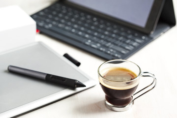 Digital tablet, stylus pen, tablet pad and cup of coffee. Select