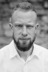 portrait of young red hair man with beard black and white