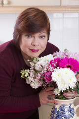 Portrait of housewife arranging decorative flowers