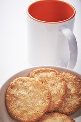 Cookies and cup of coffee or tea in office.

