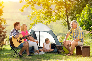 happy family camping at countryside.