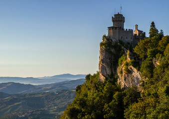 Beautiful view of the medieval fortress Cesta overlooking the green hills of San Marino republic.