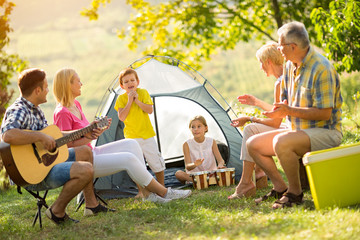 Generation family playing a guitar.