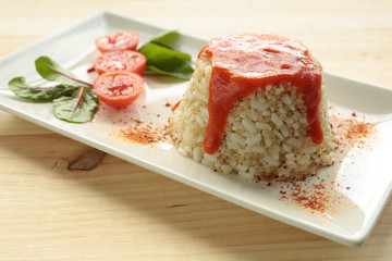 Cuban style rice on a white plate elongated