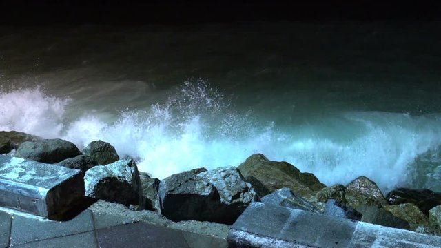 Big sea waves beating against the coastal rocks. Big splashes of the ocean waves crashing on the rocks