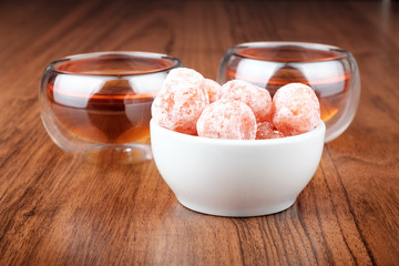 Tea in cups and kumquat
