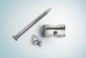 Nail and sharpener. Creative concept