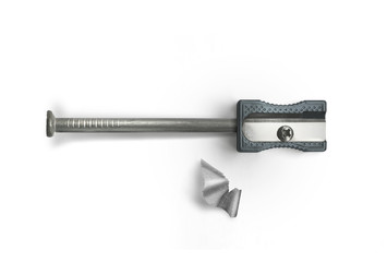 Nail and sharpener on a white background. Creative concept