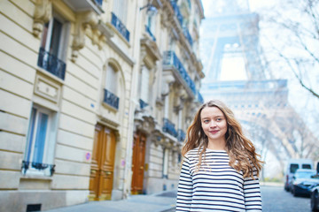 Young girl near the Eiffel tower, in Paris