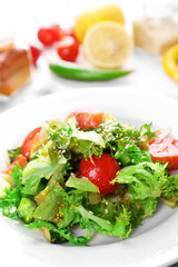 Tasty salmon salad on light wooden background