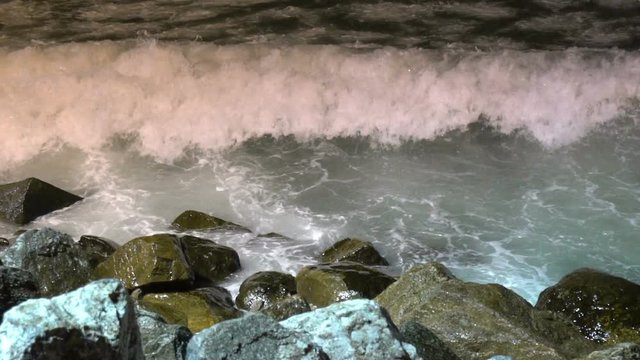 Big sea waves beating against the coastal rocks. Big splashes of the ocean waves crashing on the rocks