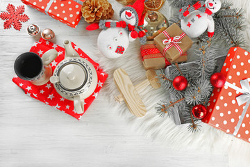 Christmas background. Decorations, cones, gift boxes on white wooden background