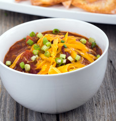 chili con carne bowl over a wooden table