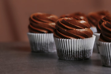Chocolate cupcakes on grey background, close up
