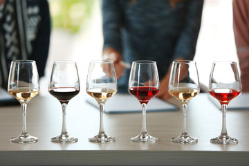 Many glasses of different wine in a row on a table. Tasting wine concept