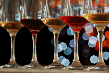 Many glasses of different wine in a row, close up