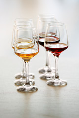 Many glasses of different wine on a table