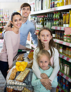Pleasant customers with children buying food in hypermarket