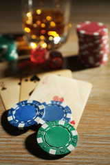 Set to playing poker with cards and chips on wooden background