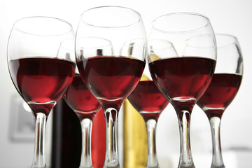 Glasses of red wine on white table closeup