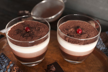 Delicious dessert with chocolate powder and rowan in glass