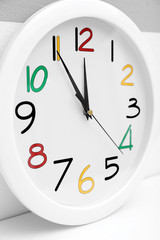 Round wall clock with colorful figures, close up