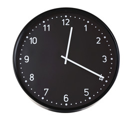 Round black wall clock, isolated on white