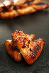 Baked chicken wings on slate plate