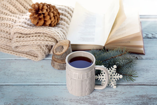 Beautiful winter composition on windowsill with cup of hot drink