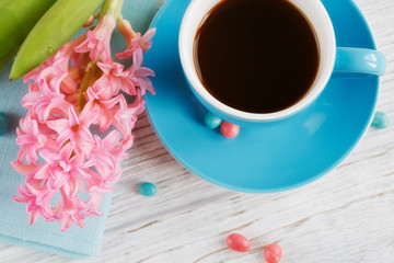 Cup of black coffee and pink flower