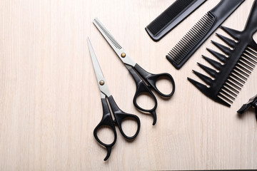 Barber set with tools on light wooden table