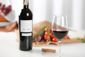 Glass of wine with food on blurred background