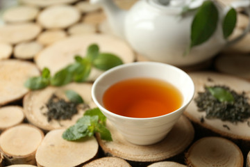 Cup of tea and teapot on table