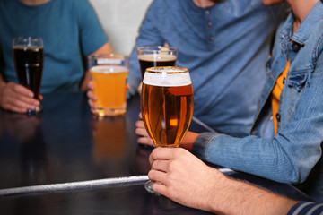 Group of young people drinking beer in a bar