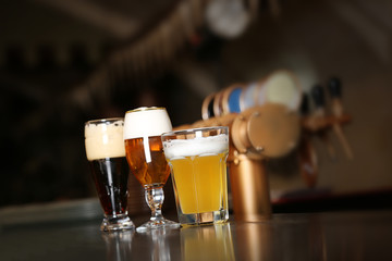 Fototapeta na wymiar Three glasses of beer in a bar