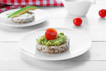 Avocado sandwiches with tomatoes on wooden background