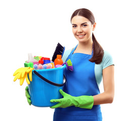 Young woman holding cleaning tools and products in bucket, isolated on white