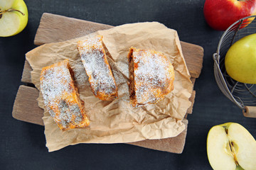 Slices of strudel with apples, walnut and raisins on parchment