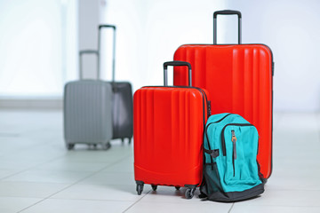 Different suitcases on tile floor