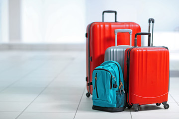 Different suitcases on tile floor
