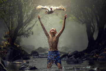 Children playing catch duck in river