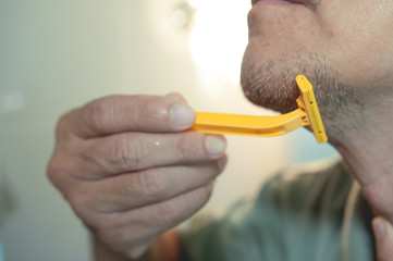 Close up, Asian old man is shaving his beard, Vintage and retro.