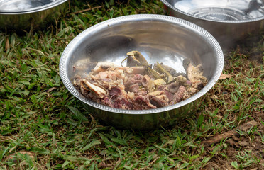 Hot cooked buffalo meat in the plate at the funeral ceremony in Tana Toraja