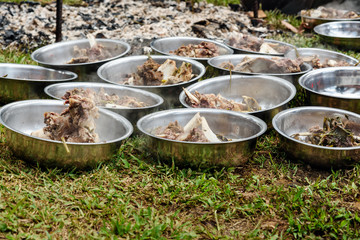 Hot cooked buffalo meat in the plates at the funeral ceremony in Tana Toraja