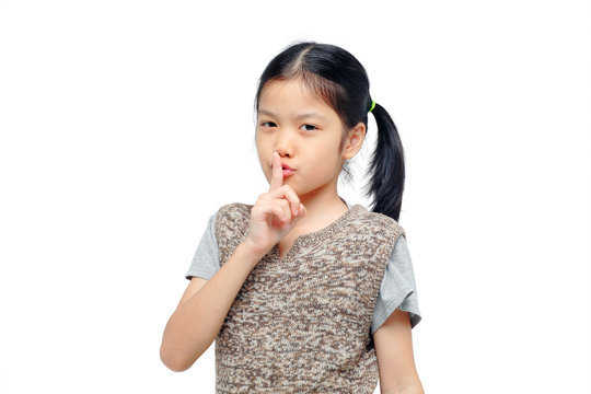 young asian girl keeping finger on her lips